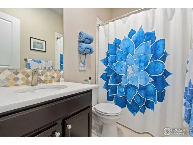 a bathroom with a sink mirror vanity and toilet