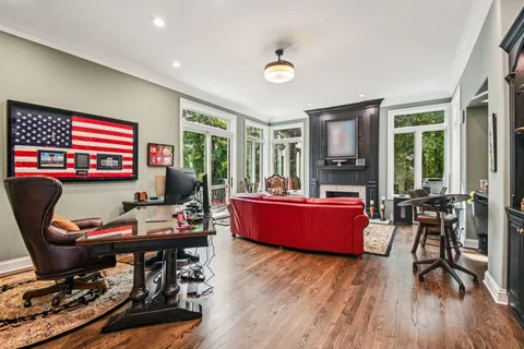 a living room with furniture a ceiling fan and a rug