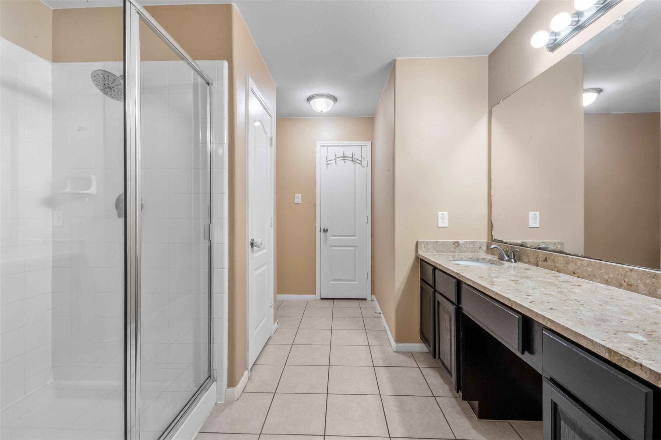 314 Gulf Winds Drive Bacliff, TX 77518 - Photo 13 of 24 a bathroom with a granite countertop sink a mirror and a shower
