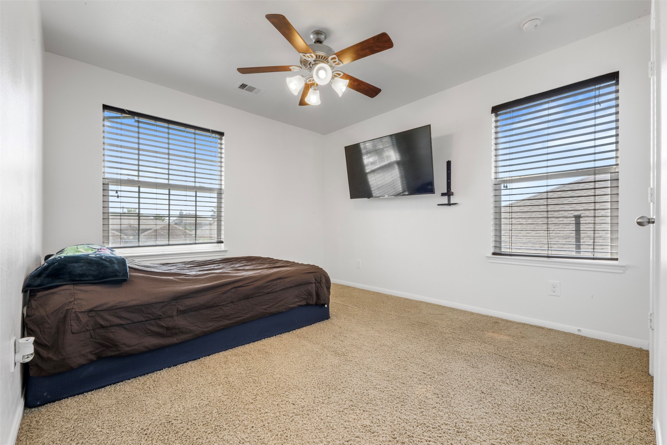 314 Gulf Winds Drive Bacliff, TX 77518 - Photo 15 of 24 a bedroom with a bed a flat screen tv and a window