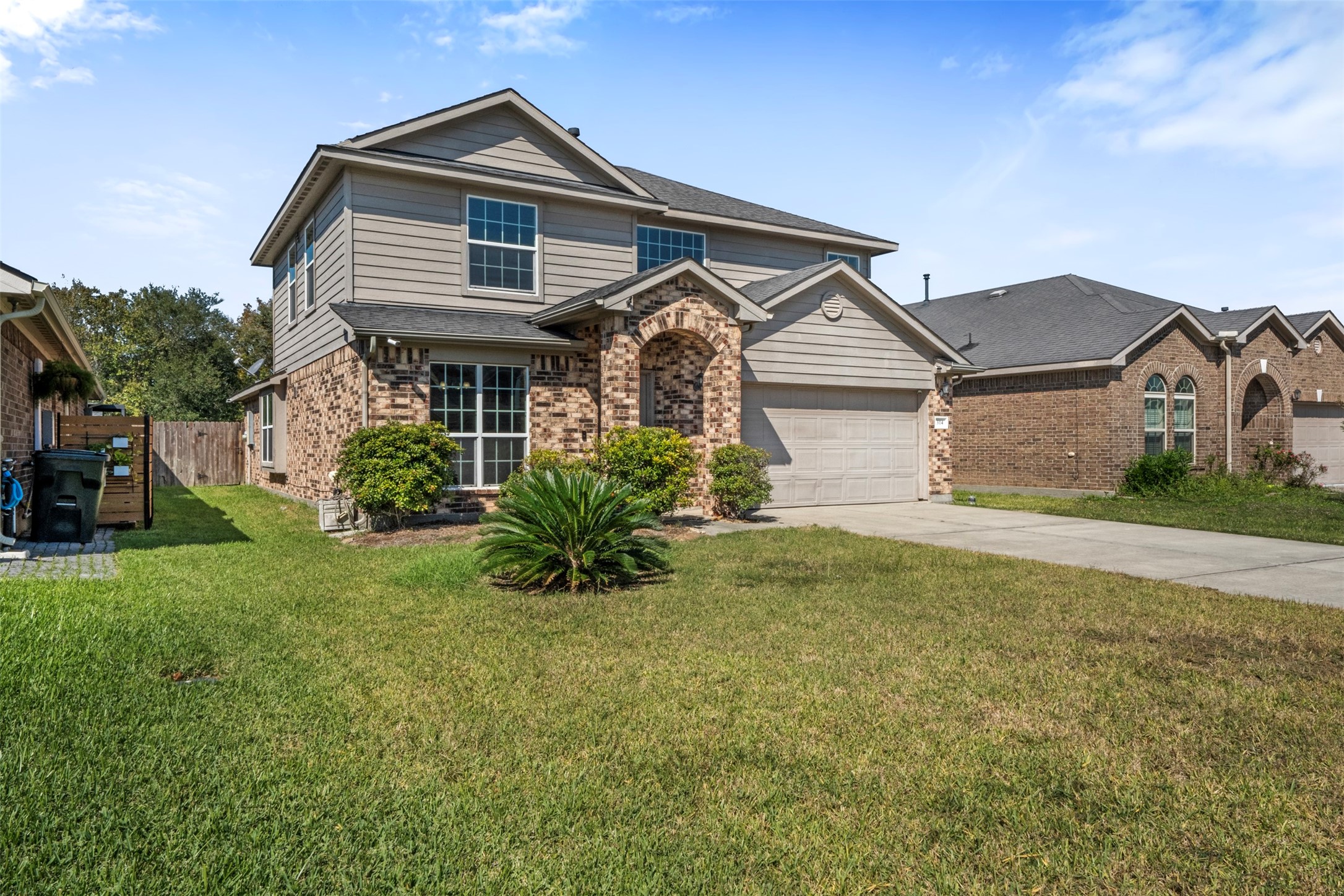 314 Gulf Winds Drive Bacliff, TX 77518 - Photo 19 of 24 a front view of a house with a yard and garage