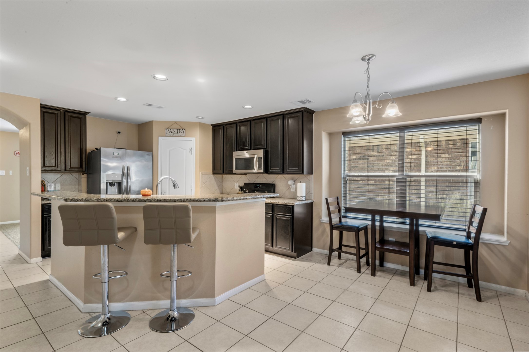 314 Gulf Winds Drive Bacliff, TX 77518 - Photo 8 of 24 a kitchen with granite countertop cabinets and refrigerator