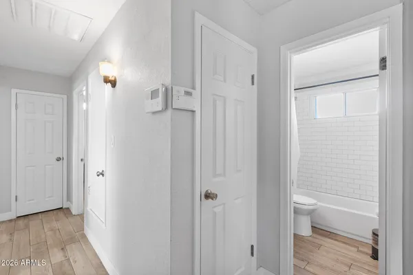 a bedroom with a bed a dresser and chair