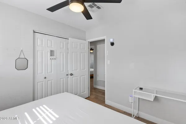a kitchen with stainless steel appliances kitchen island granite countertop a stove a sink a dining table and chairs with wooden floor