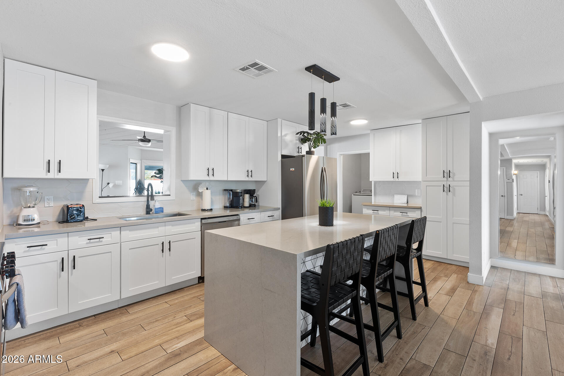 726 West 19th Street Tempe, AZ 85281 - Photo 23 of 40 a kitchen with stainless steel appliances kitchen island granite countertop a table chairs sink and cabinets