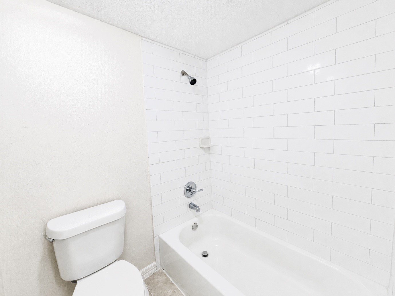 8407 Riverside Walk Lane Houston, TX 77064 - Photo 24 of 33 Bright primary bathroom with a tub/shower combination and updated subway tile.