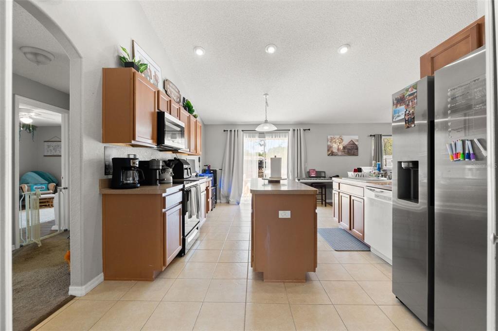 15335 Fleetwood Road Weeki Wachee, FL 34614 - Photo 22 of 40 a kitchen with stainless steel appliances granite countertop a refrigerator and a stove