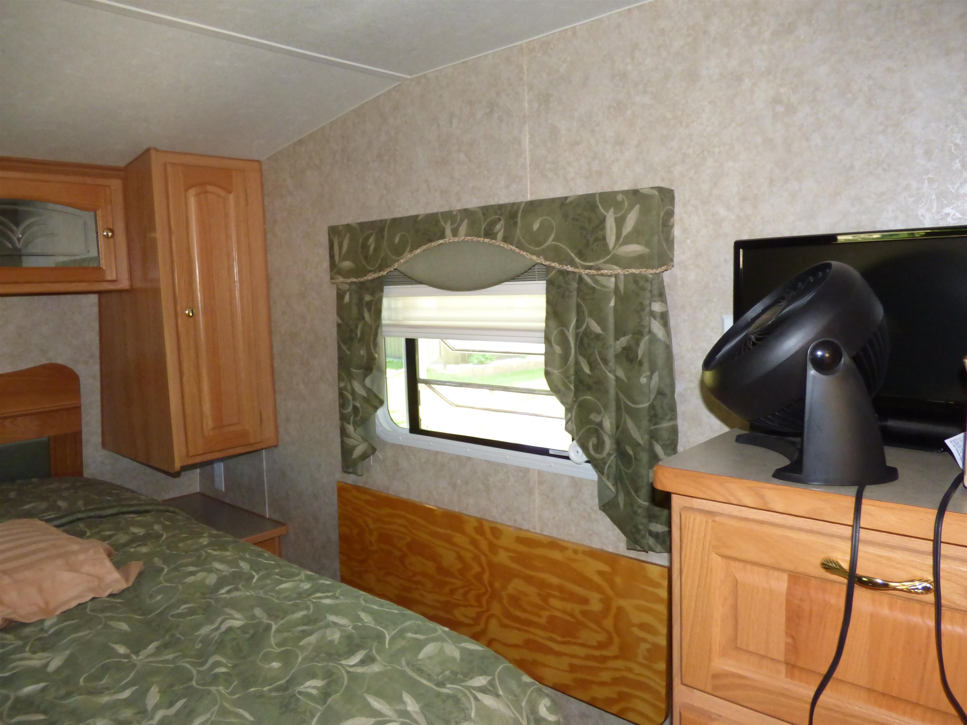 6384 A Diehl Road Savanna, IL 61074 - Photo 18 of 32 a bedroom with a bed and cabinets