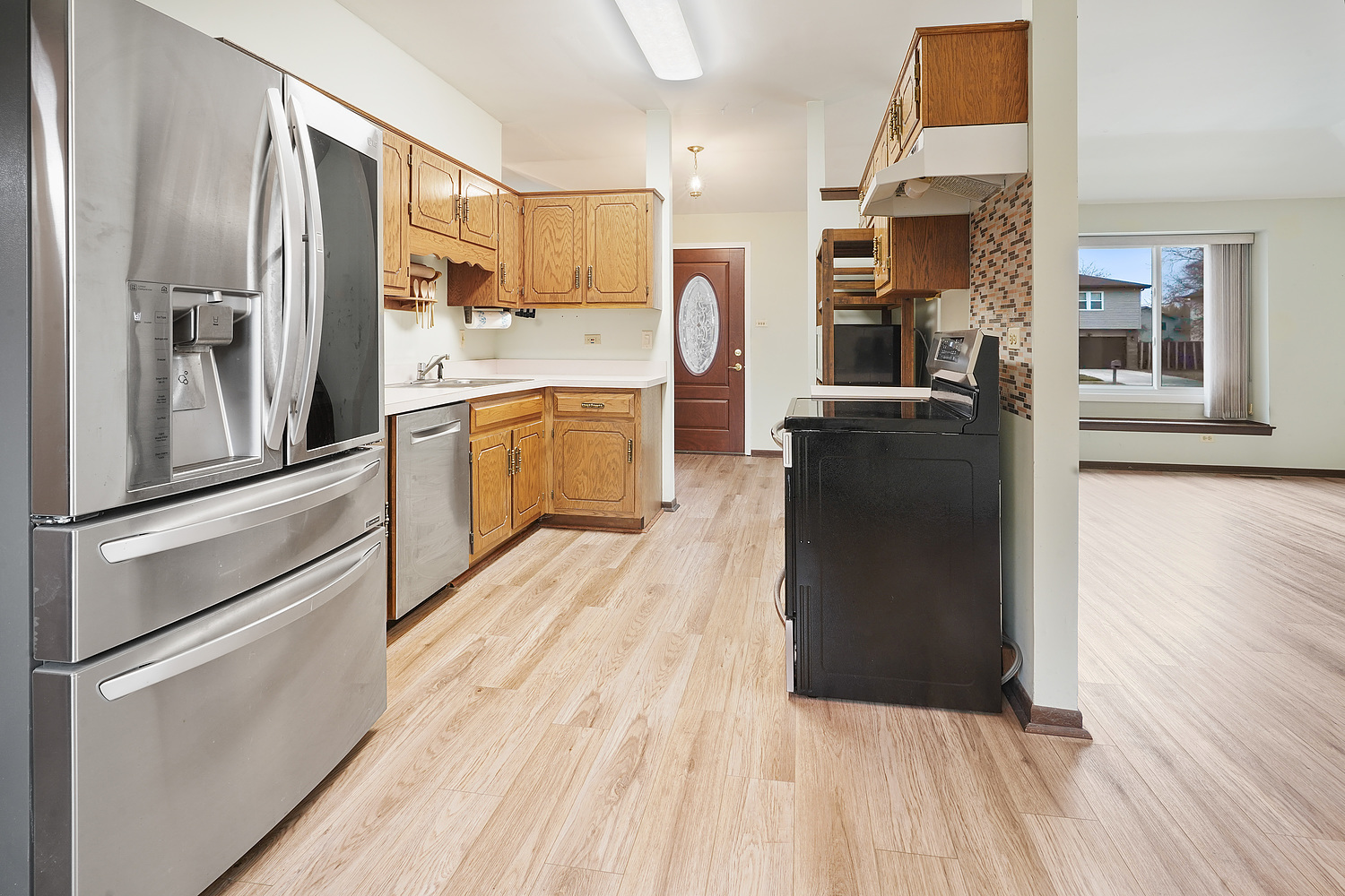 120 Timberlane Road Matteson, IL 60443 - Photo 10 of 19 a kitchen with a refrigerator and wooden floor