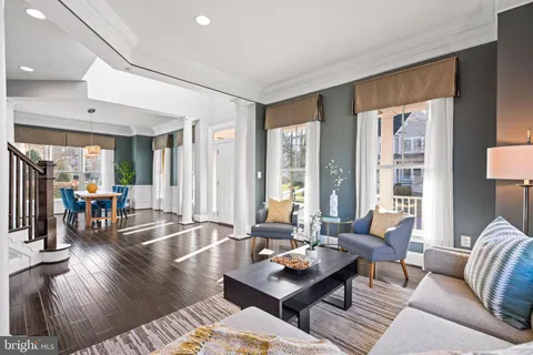 a living room with furniture and large windows