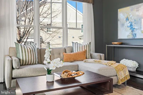 a kitchen with stainless steel appliances granite countertop a refrigerator a stove a sink a dining table and chairs