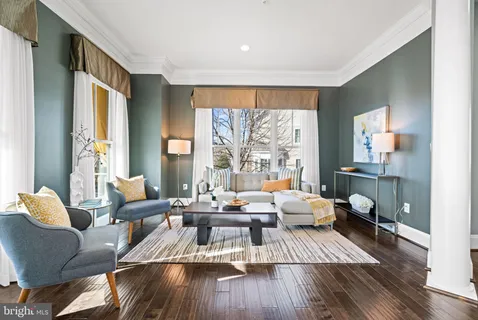 a kitchen with stainless steel appliances granite countertop a refrigerator a stove and a wooden floors