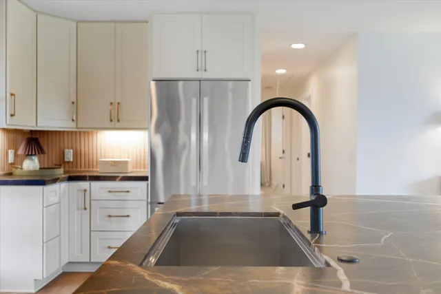 a kitchen with a sink a stove and cabinets