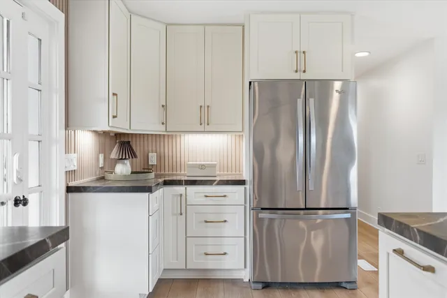 a kitchen with stainless steel appliances granite countertop a refrigerator sink and cabinets