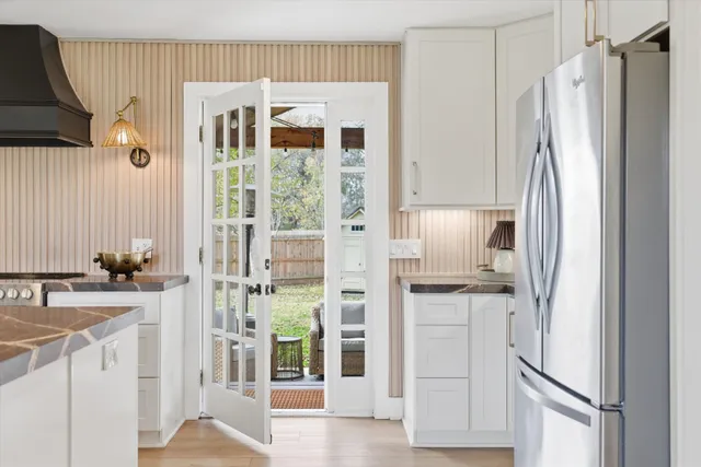 a kitchen with a refrigerator and a sink