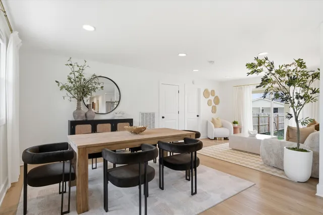 a view of a dining room with furniture and a potted plant