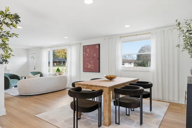 a view of a dining room with furniture and window