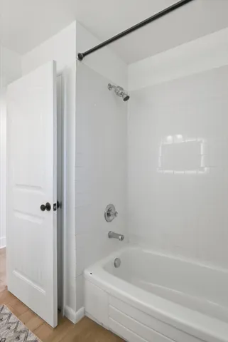 a bathroom with a bathtub and a shower
