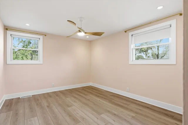 wooden floor in an empty room with a window