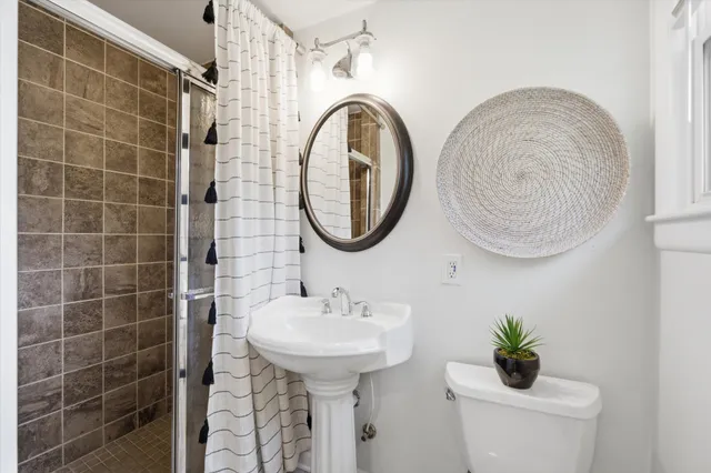 a bathroom with a sink a mirror and a shower