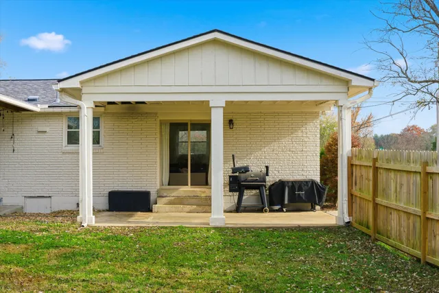 a view of a house with backyard and porch