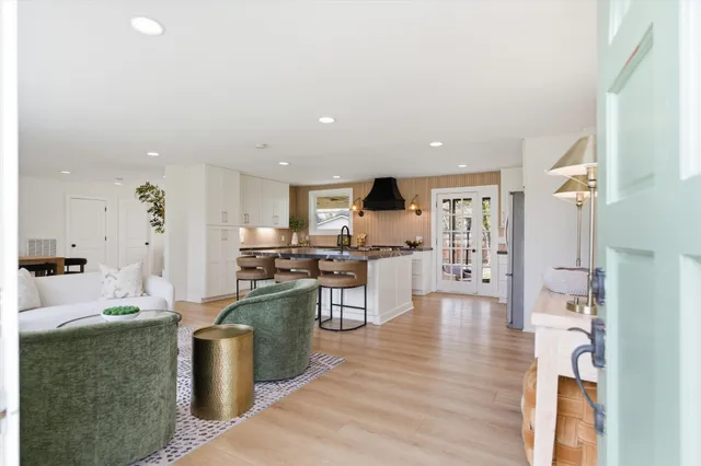 a kitchen with stainless steel appliances kitchen island granite countertop a sink and cabinets