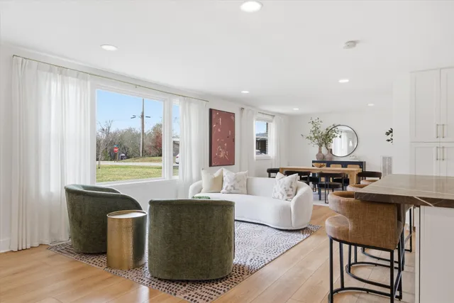 a living room with furniture a fireplace and a window