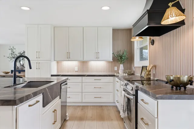 a kitchen with a sink stove and cabinets