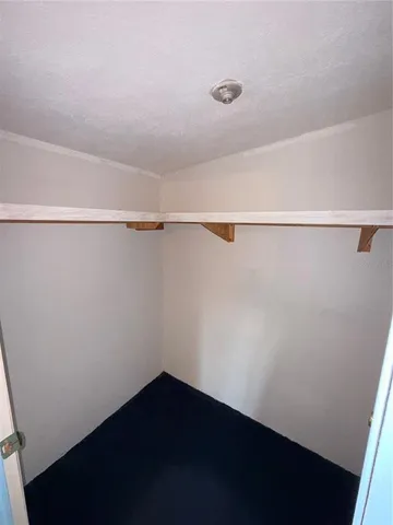 a view of a room with shelf on the wall
