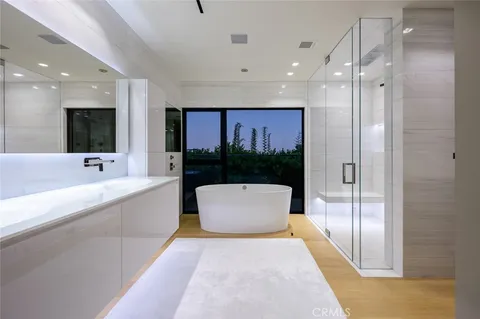 a large bathroom with a bathtub and a sink
