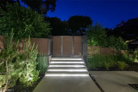 a view of a house with a porch next to a road