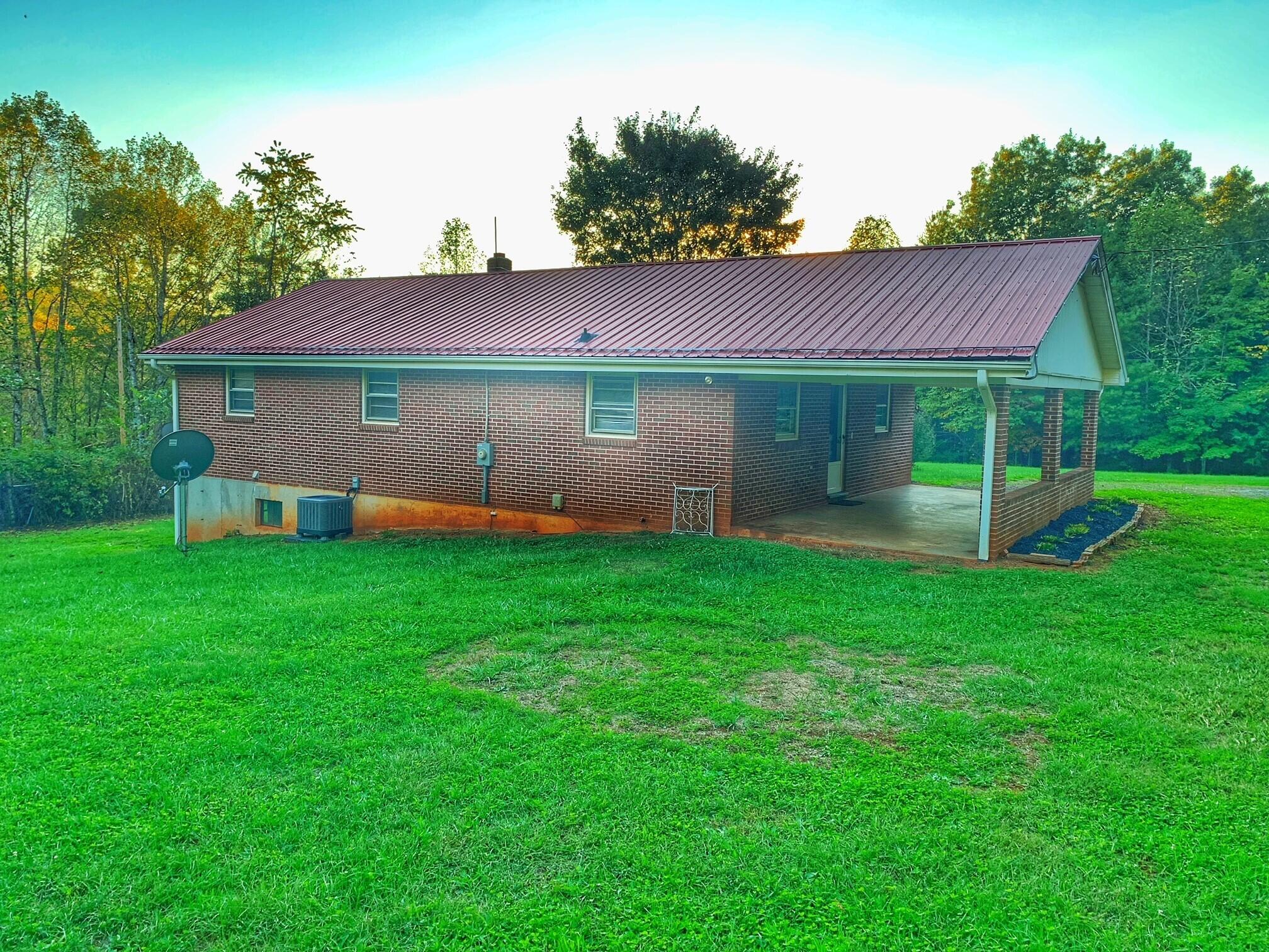 5260 Haw Patch Road Ferrum, VA 24088 - Photo 6 of 46 a backyard of a house with table and chairs