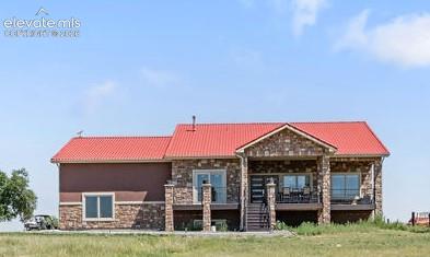 8450 Edison Road Yoder, CO 80864 - Photo 2 of 50 a front view of a house with garden