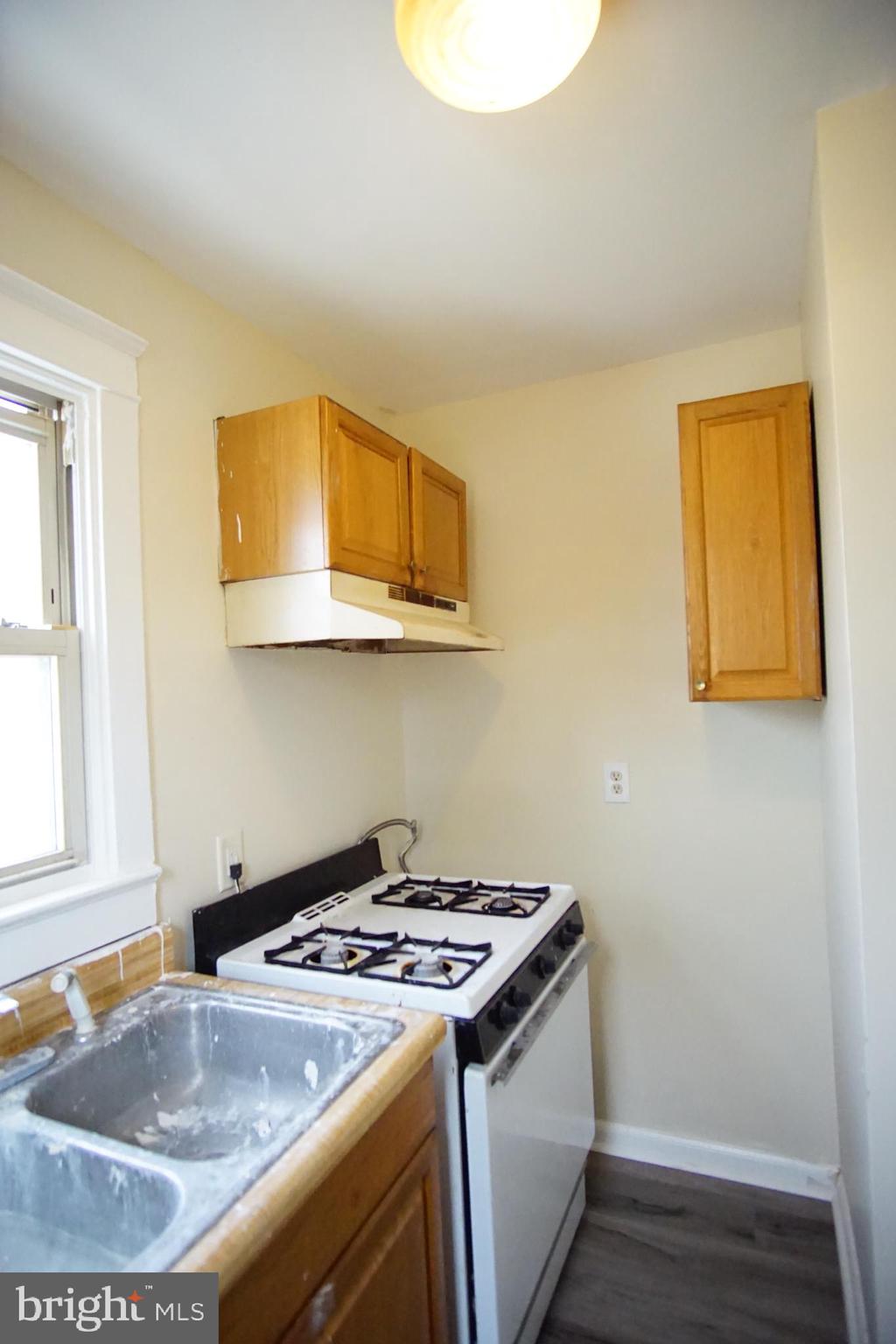 5200 Ballman Avenue, Unit 3 Baltimore, MD 21225 - Photo 11 of 17 a kitchen that has a sink and a stove