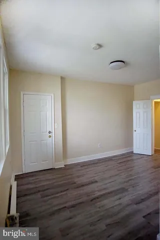 a view of an empty room and wooden floor