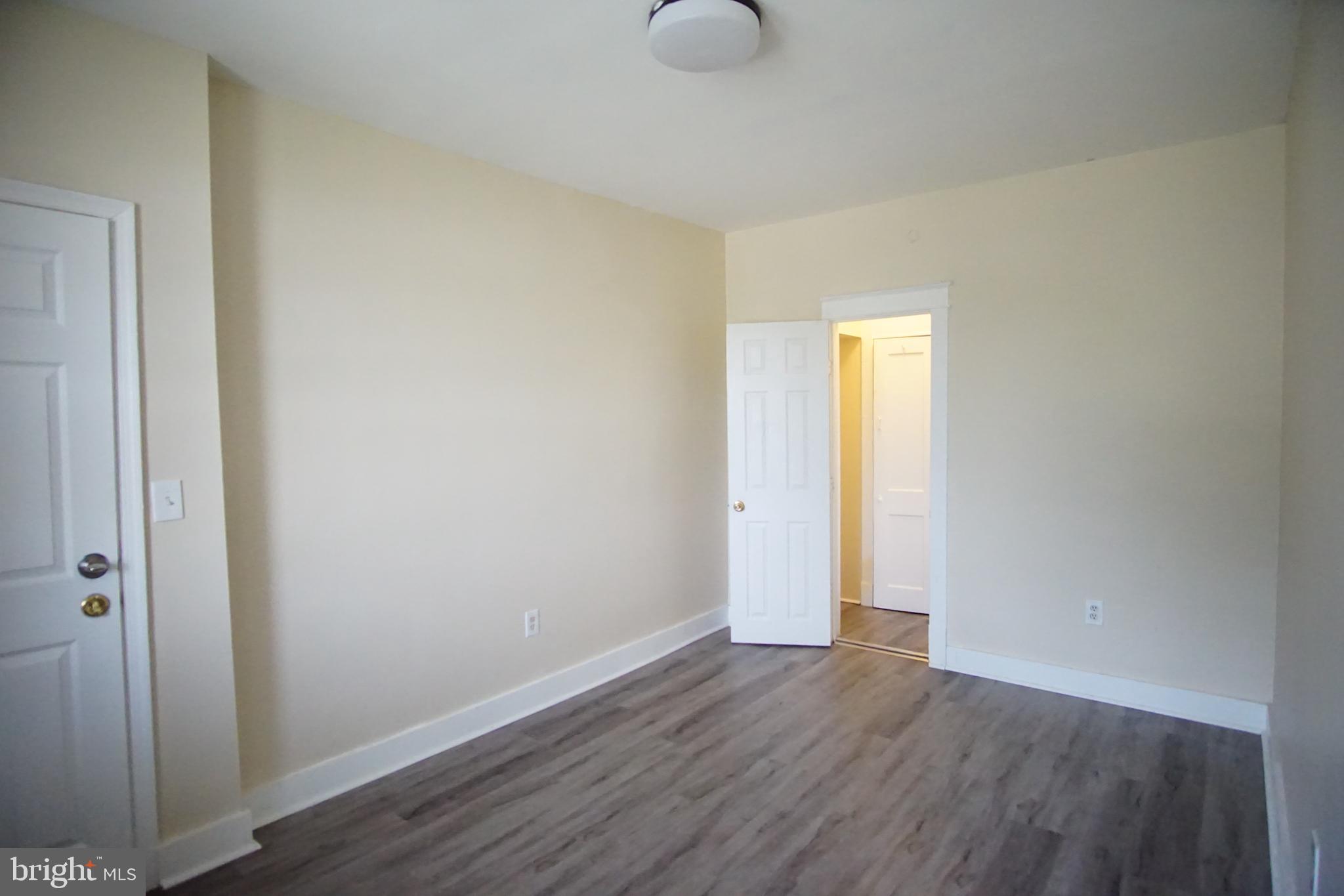 5200 Ballman Avenue, Unit 3 Baltimore, MD 21225 - Photo 3 of 17 a view of an empty room with wooden floor
