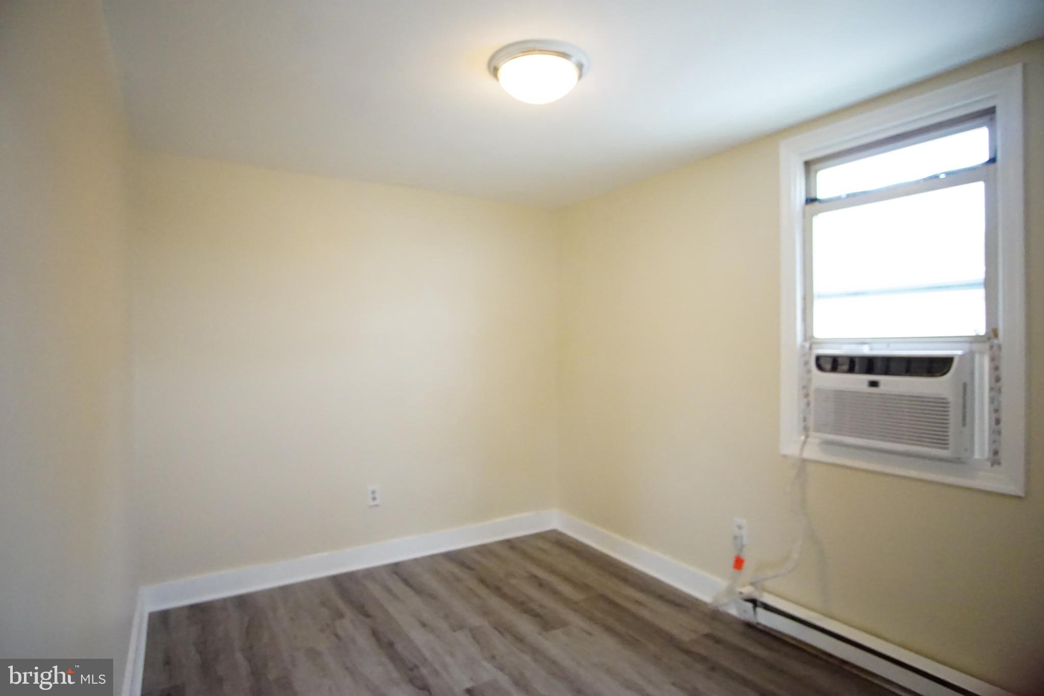 5200 Ballman Avenue, Unit 3 Baltimore, MD 21225 - Photo 8 of 17 an empty room with a window
