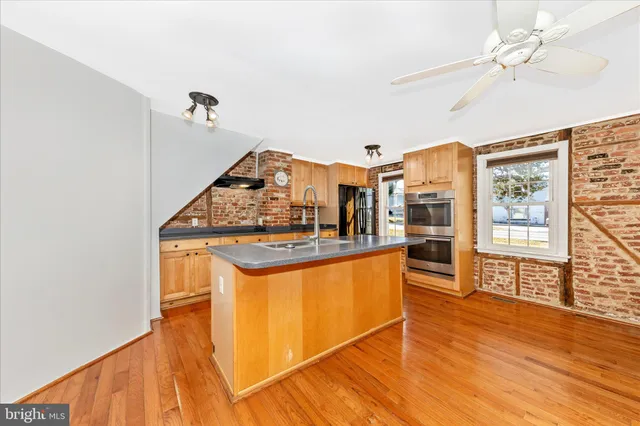 a view of a large kitchen with a sink and cabinets