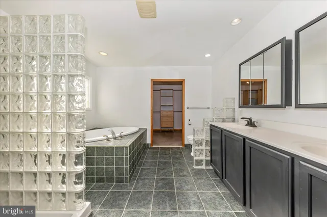 a view of an empty room with cabinet and a window