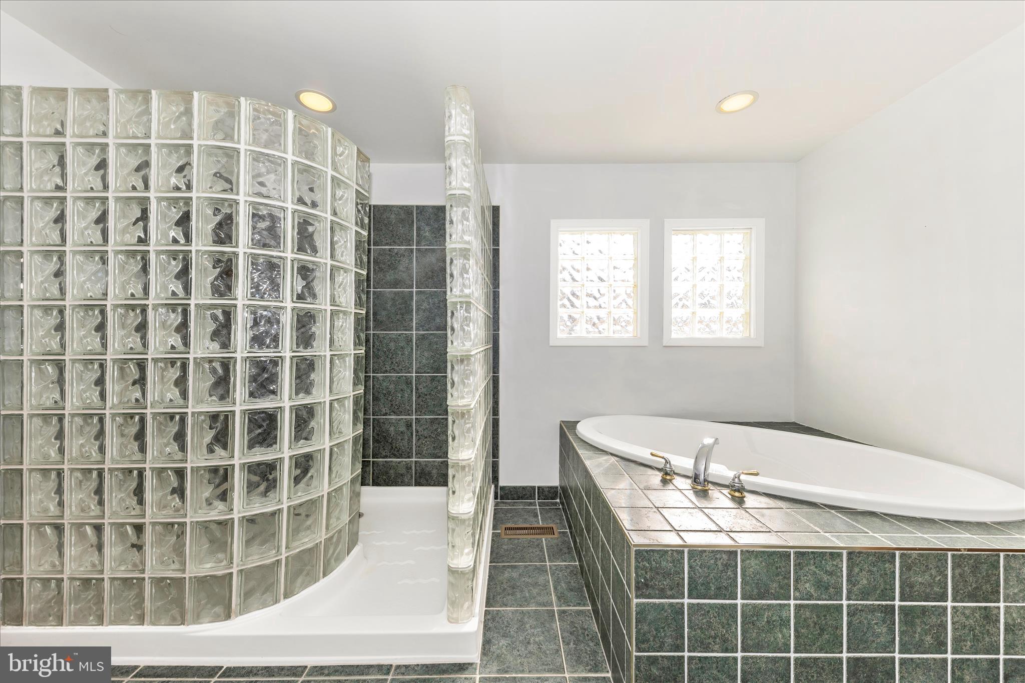 8204 Ball Road Frederick, MD 21704 - Photo 22 of 55 a bathroom with a double vanity sink and a bathtub