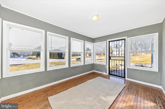 an empty room with a empty space and windows