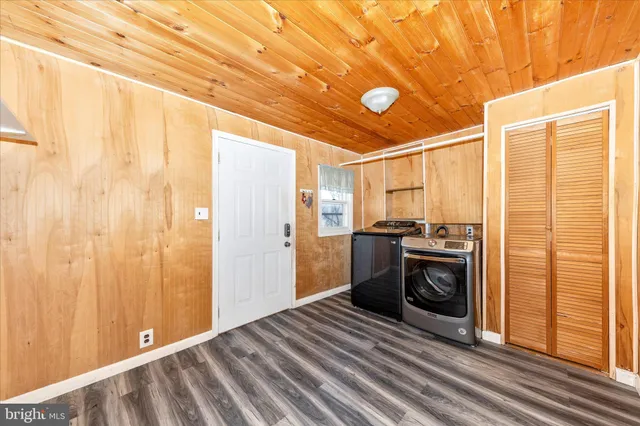 an empty room with windows and chandelier fan