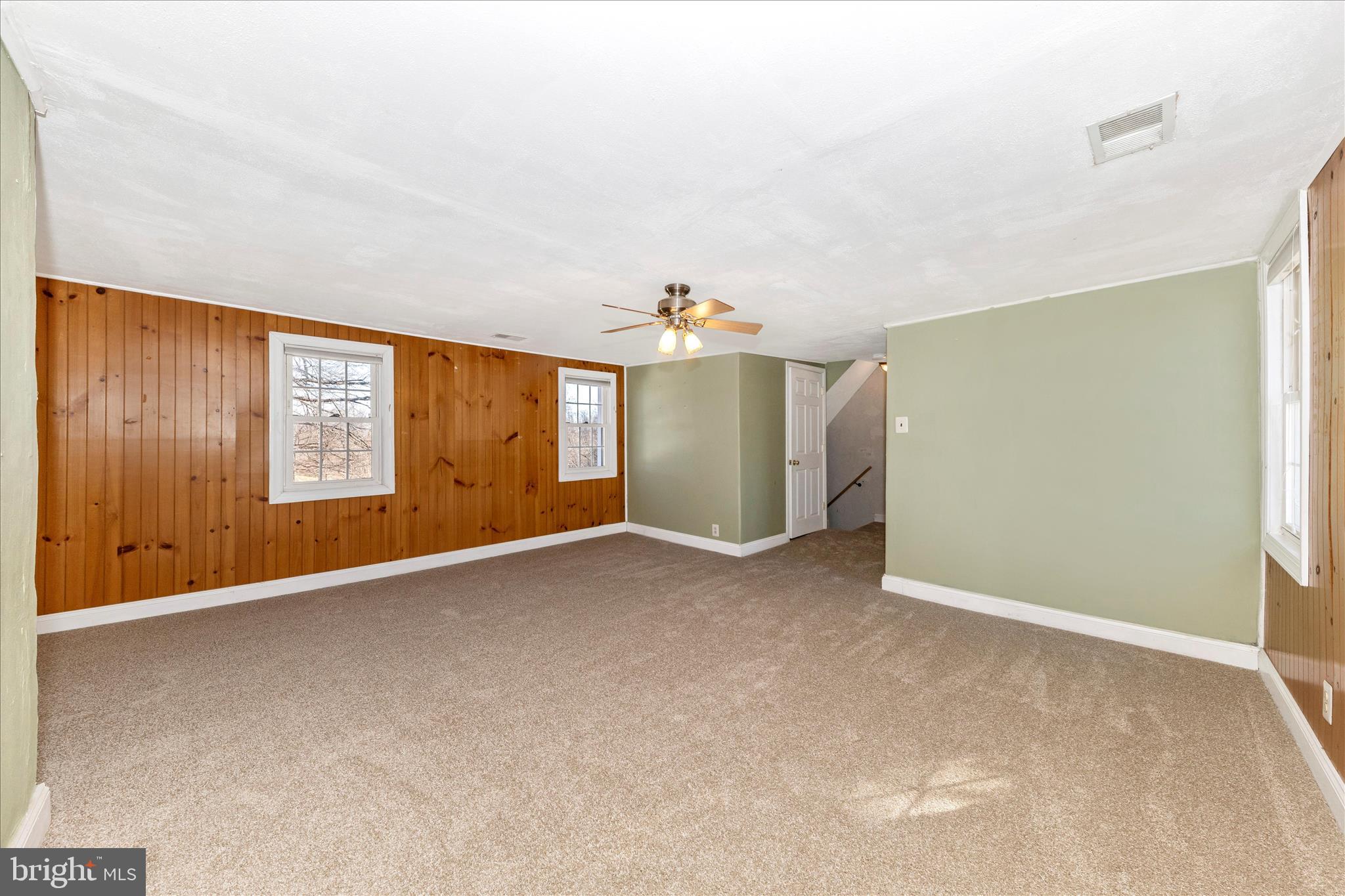 8204 Ball Road Frederick, MD 21704 - Photo 29 of 55 an empty room with windows and chandelier fan