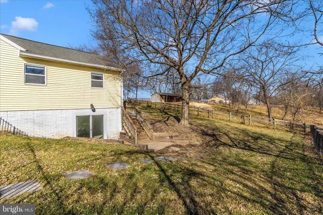 a view of a house with wooden fence