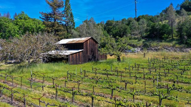 a backyard of a house with a yard and outdoor seating