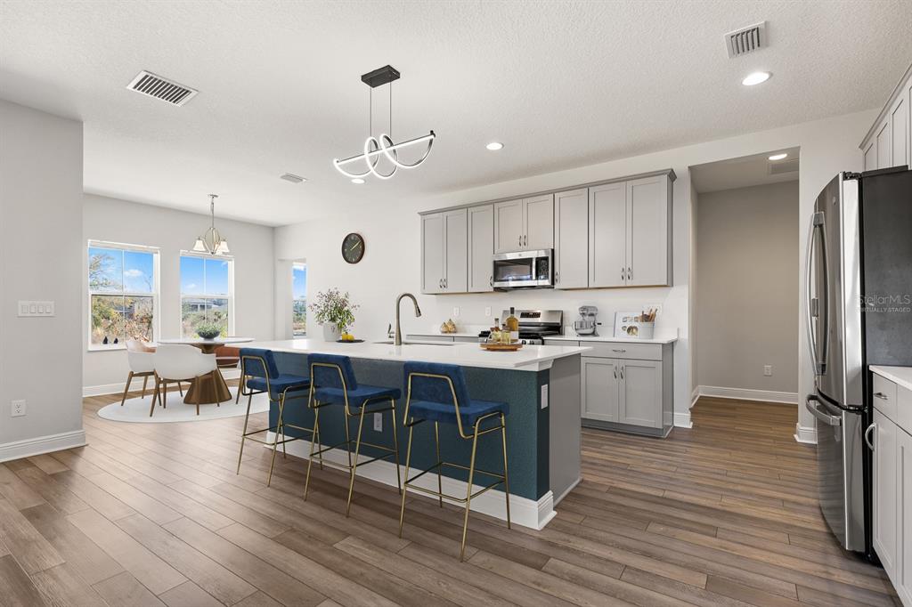 14671 Horse Trot Road Lithia, FL 33547 - Photo 4 of 40 a large kitchen with lots of counter space a sink appliances and cabinets