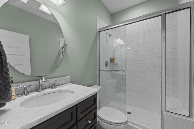 a bathroom with a sink double vanity and a mirror