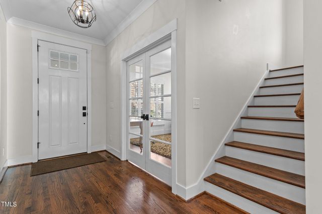 a view of a hallway with wooden floor and entryway
