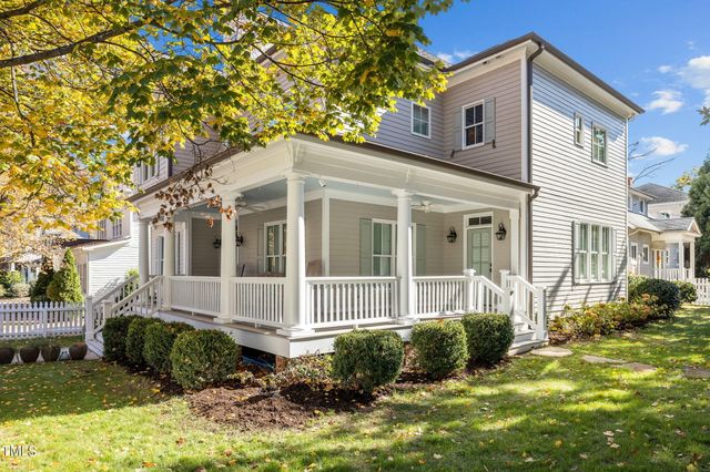 a view of a house with a chairs and table in a patio
