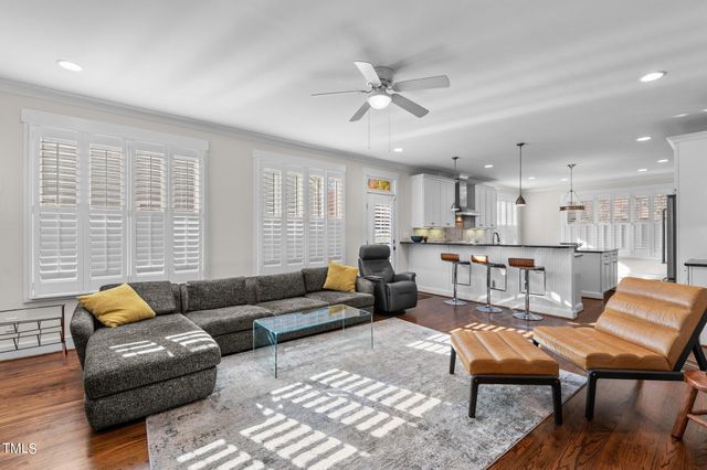 a kitchen with stainless steel appliances granite countertop a sink a stove and a wooden floors
